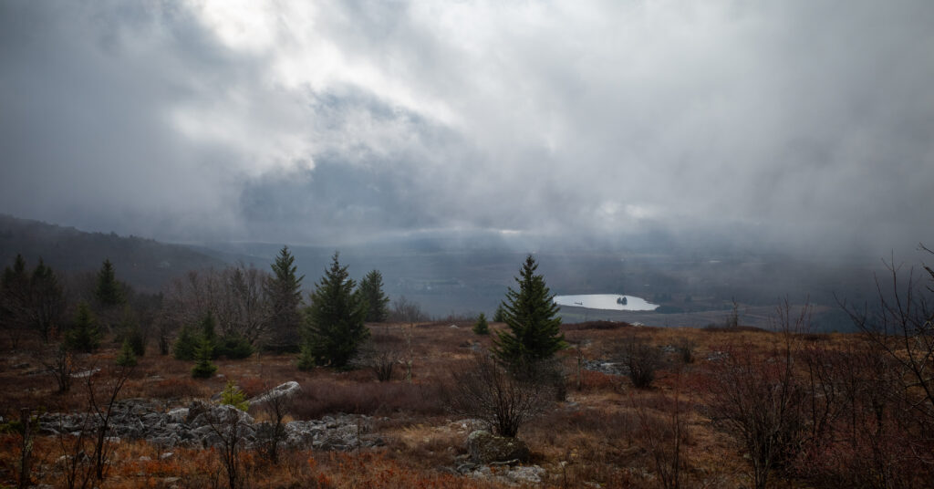Low clouds above the rocky and spruce-covered plateau on Rocky Ridge Trail