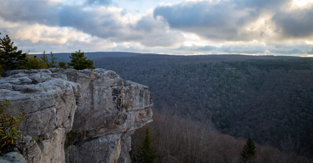 Sandstone cliffs at Lion's Head catching early morning light above a forested ridge
