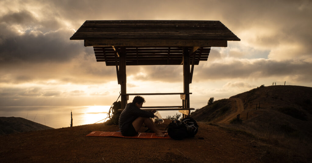 Sunset over a trail bench before the descent to Parsons Landing