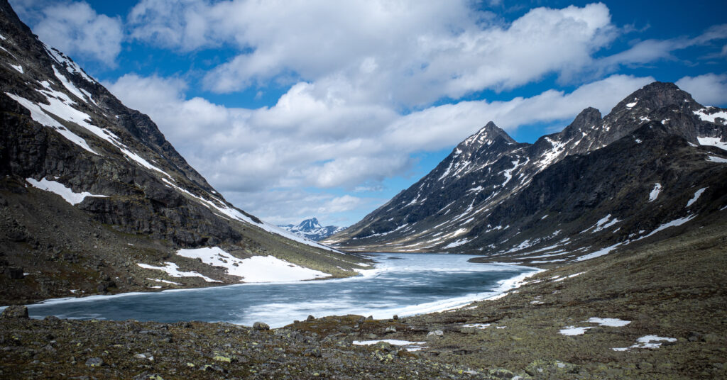 Frozen lake between snow-covered mountains in Svartdalen