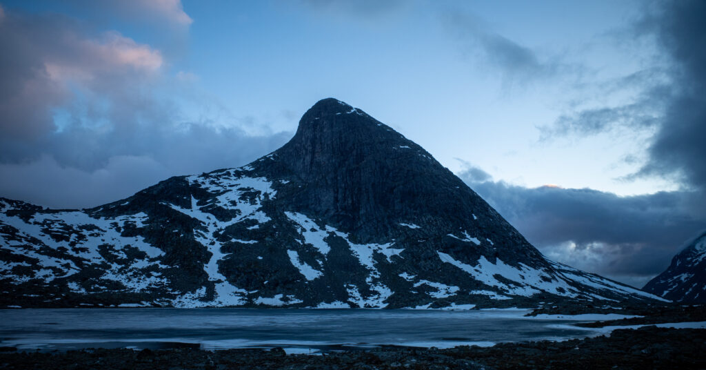 Mjølkedalstinden above a frozen lake near the second campsite