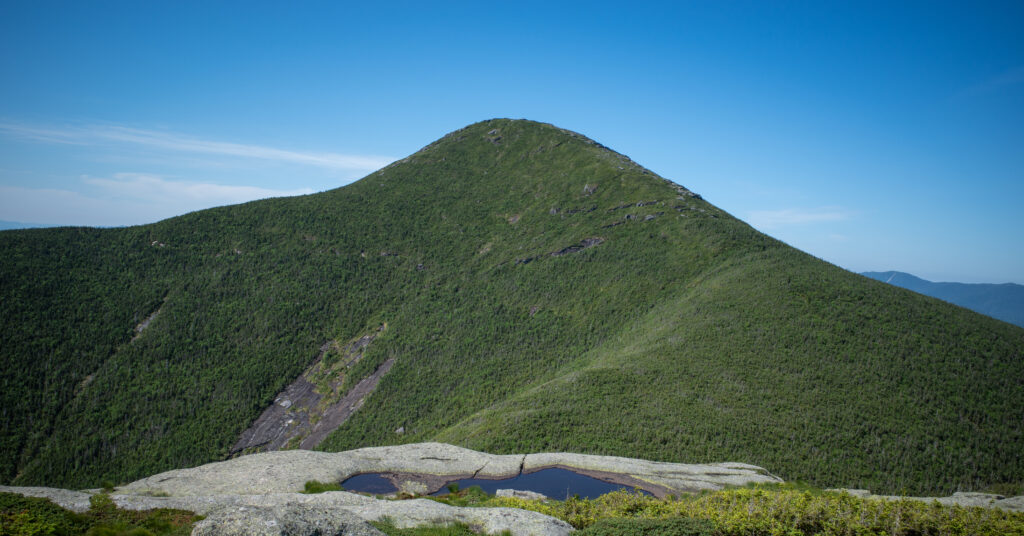 Algonquin Peak viewed from Wright Peak above alpine bedrock and shallow pools