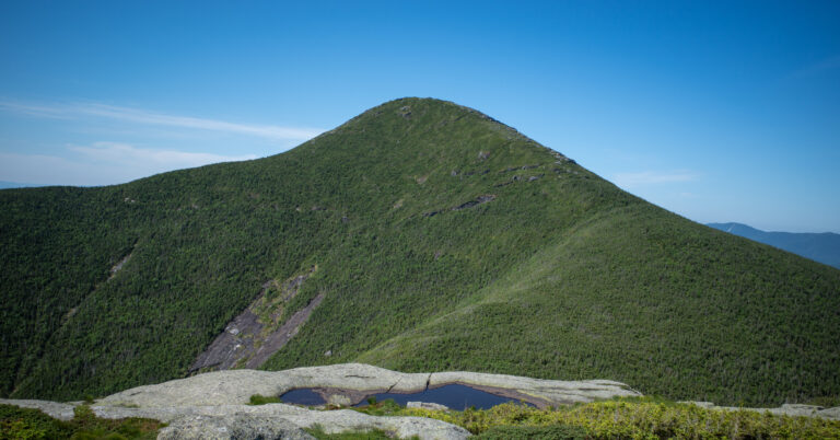 Algonquin Peak viewed from Wright Peak above alpine bedrock and shallow pools