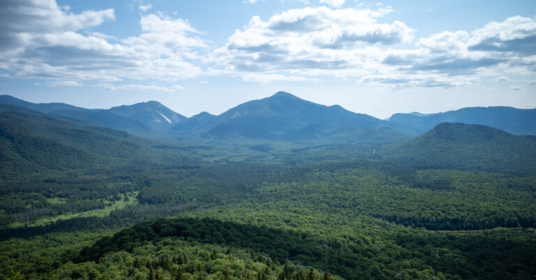 Algonquin Peak and Wright Peak above a forested valley from Mount Van Hoevenberg