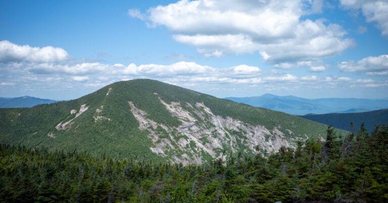 Giant Mountain's exposed eastern face rising above dense forest.