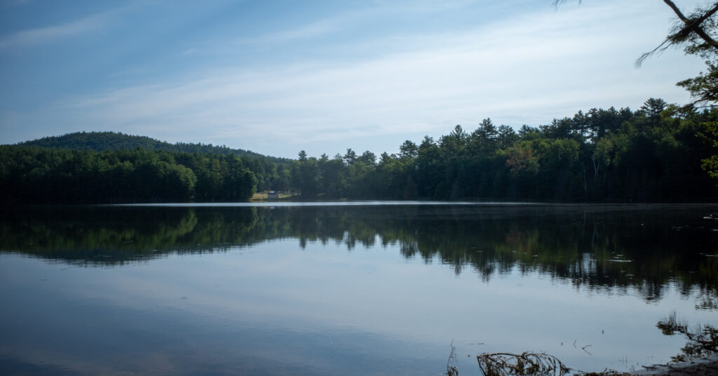 Edgecomb Pond reflecting a forested shoreline near the Cat Mountain trailhead