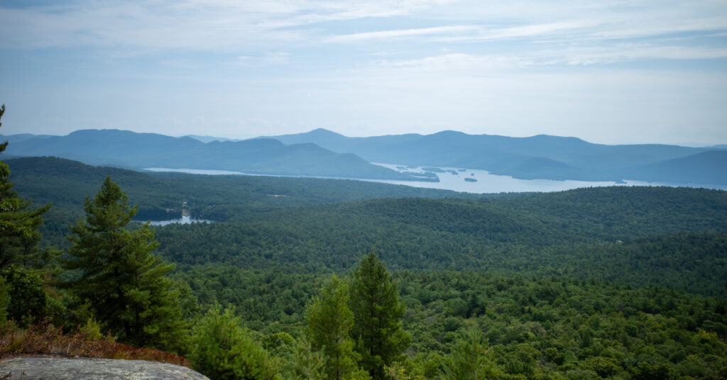 Lake George and several islands between forested ridges from Cat Mountain