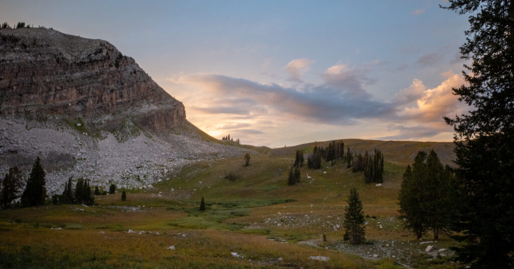 Sunset behind a rocky slope and open meadow near Marion Lake